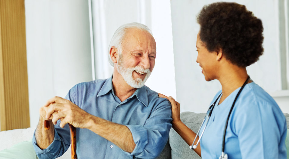 Elderly talking to caregiver